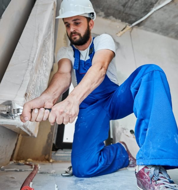 plumber-screwing-plumbing-fittings-with-a-wrench.jpg